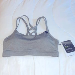Brand new w tags- strappy, stylish Nike training bra. DRI-FIT technology.